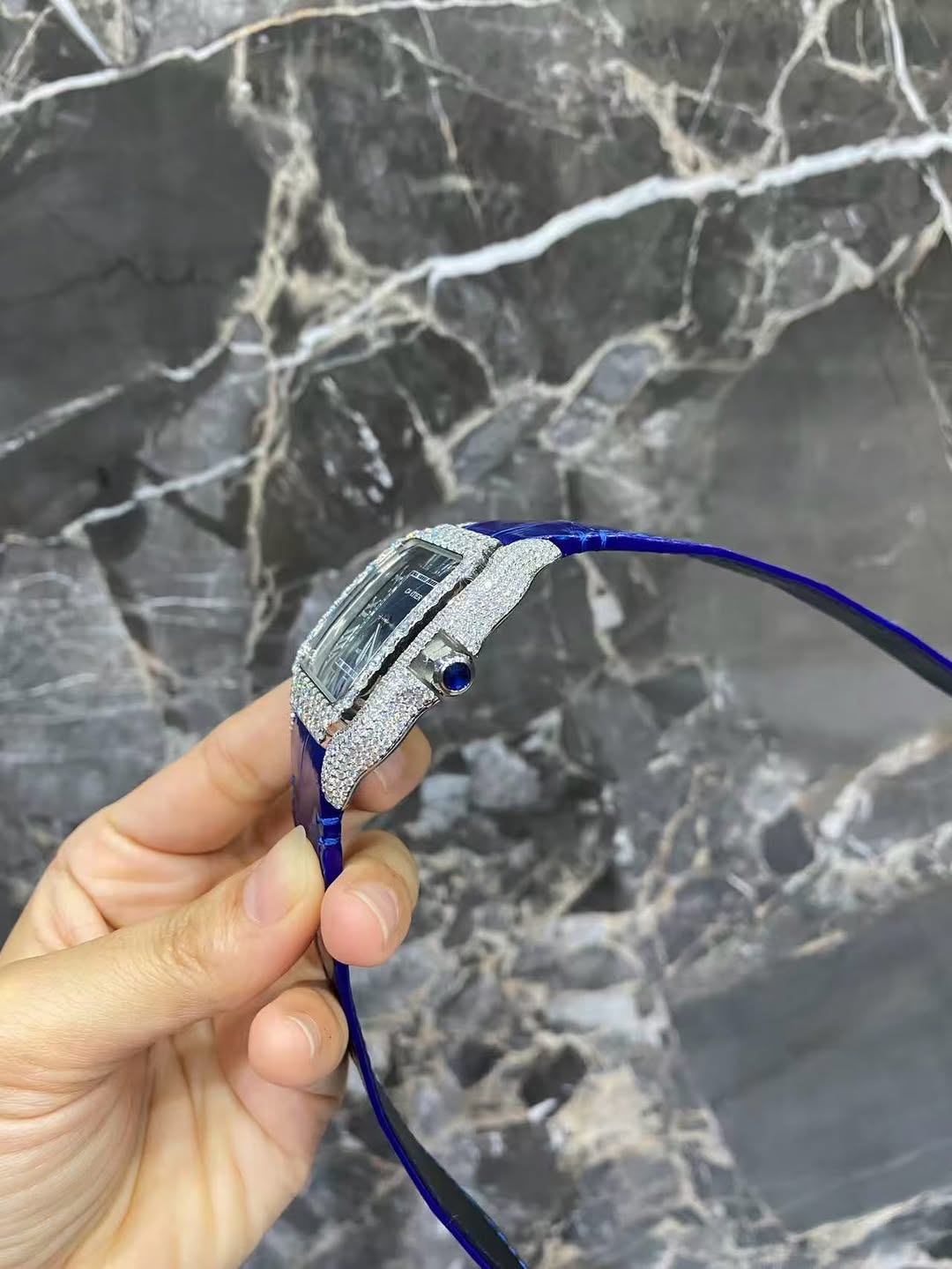 Side profile of the Moissanite Cartier Santos Watch showing the blue leather strap and case thickness