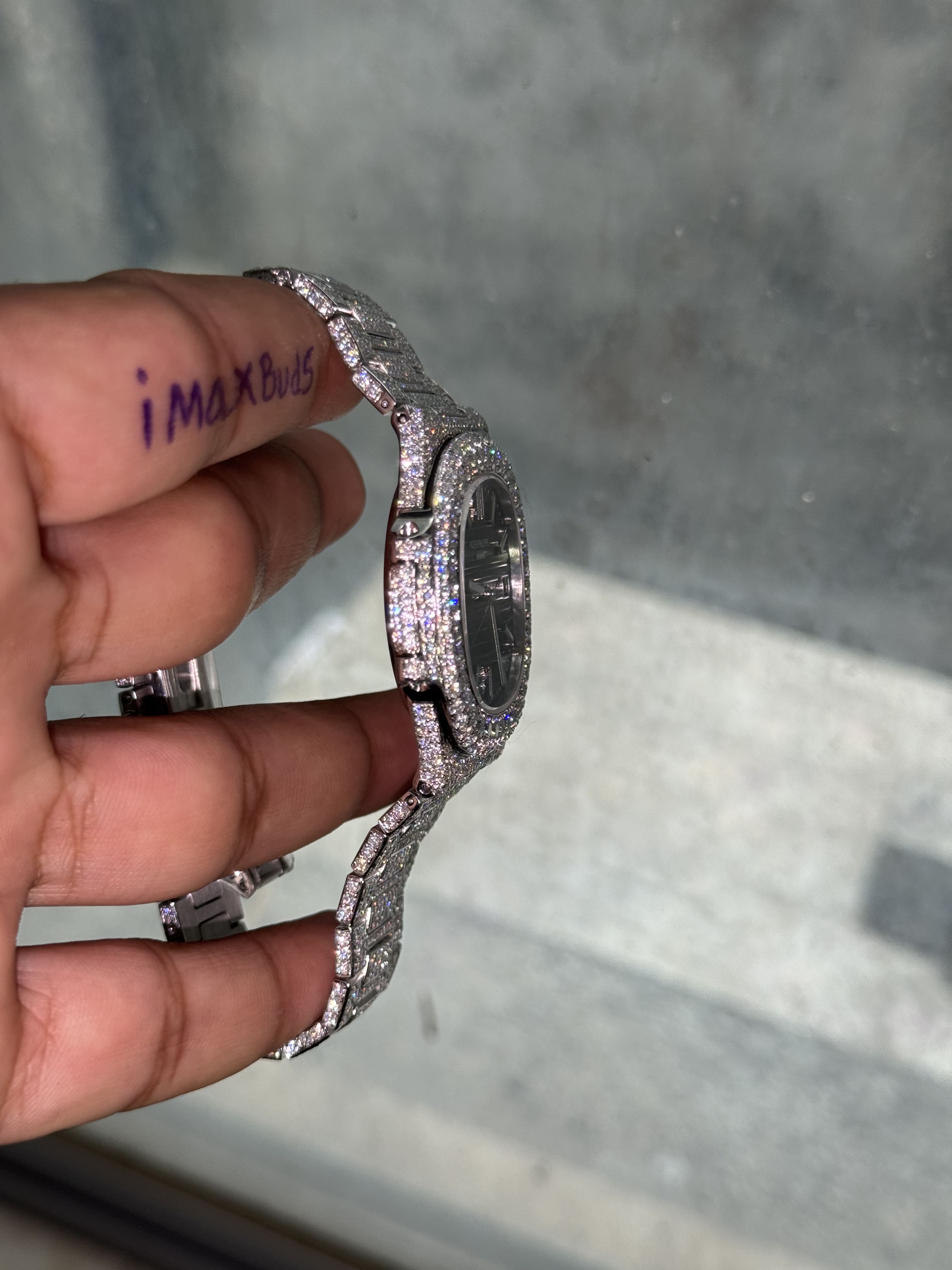 Side profile iced out Patek Philippe Nautilus Watch