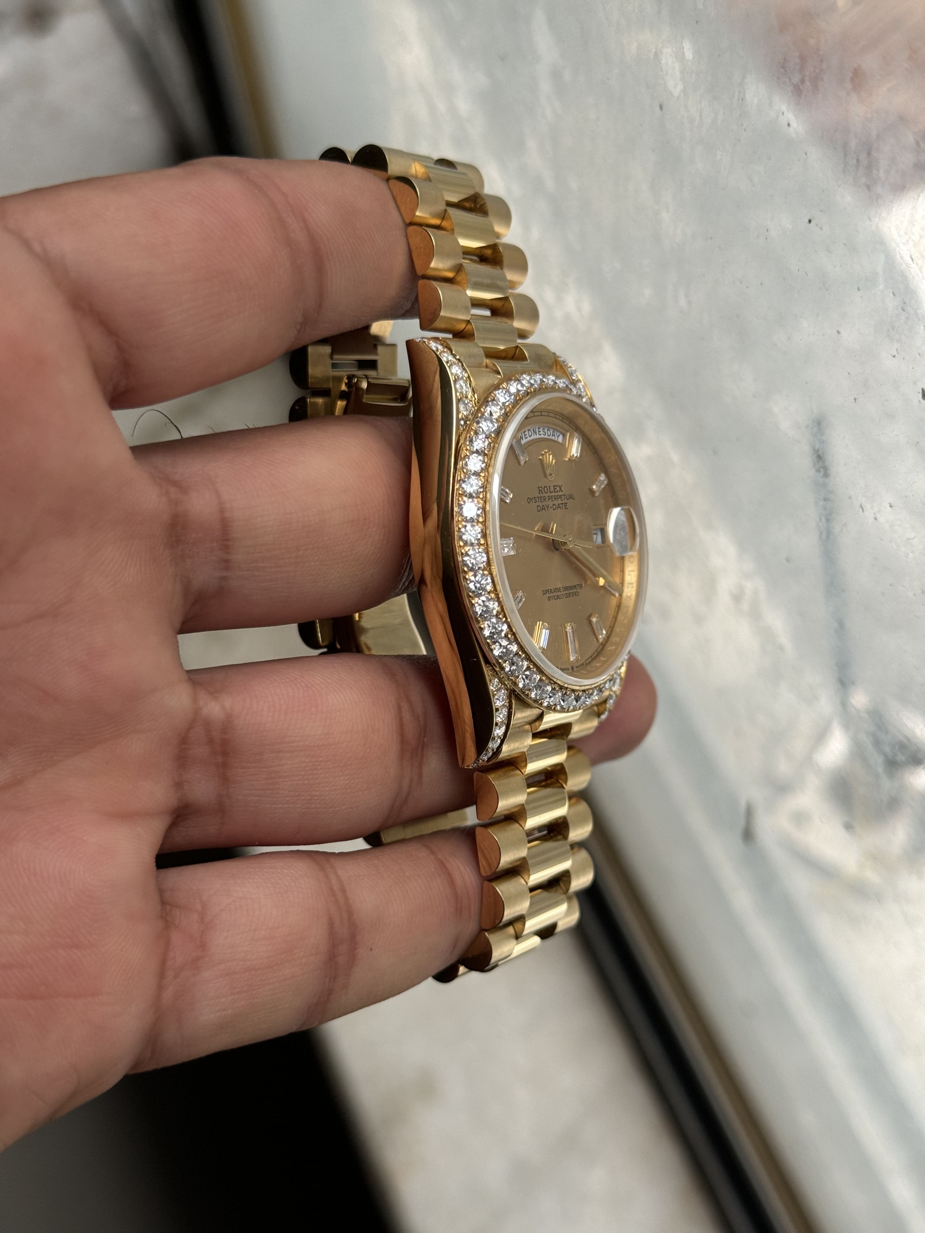 Polished yellow gold presidential bracelet on custom moissanite watch